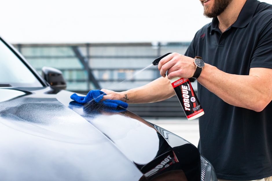 Microfiber cloth carefully wiping down vehicle exterior